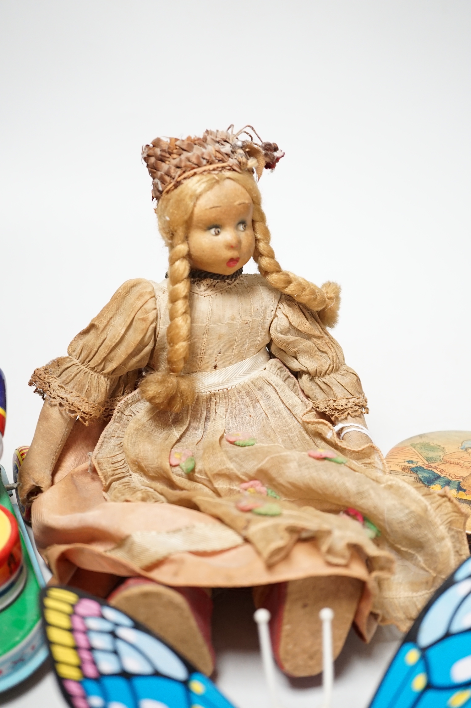 Two tin plate clockwork toys, a doll and a treen box
